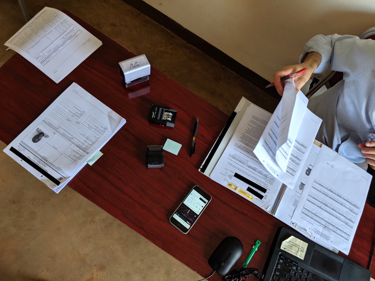 A refugee officer preparing documents for an interview.